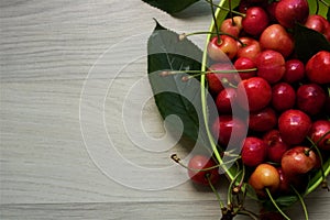 Green bowl of fresh and juice cherries