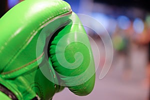 Green boxing glove with blurred background