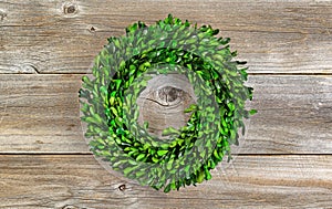 Green Boxwood Leaf Wreath on Rustic Wood