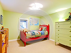 Green boys kids bedroom with red bed.