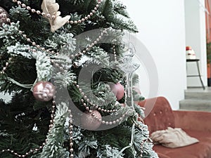 The green branch of the Christmas tree. decorated with snow and Christmas decorations. Close-up