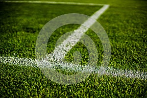 Green bright colorful grass pitch of football stafium, close up with beautiful bokeh