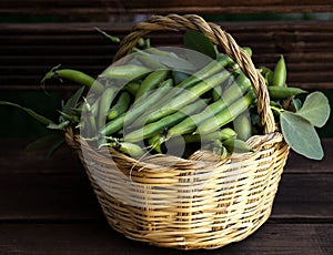 Green broad beans in a basket