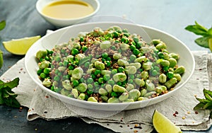 Green Broad beans and quinoa salad with sweet peas and mint. Healthy vegan food