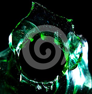 Green broken glass isolated on black background