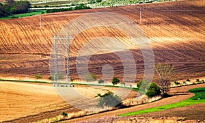 Green and brown spring ploughland. Rolling arable fields
