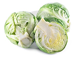 Green brussel sprouts with water drops on them on white background