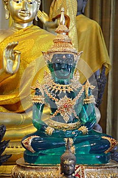 Green buddha among other buddhas