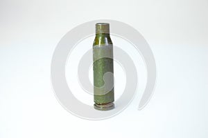 Green bullet from Kalashnikov automatic rifle at white background