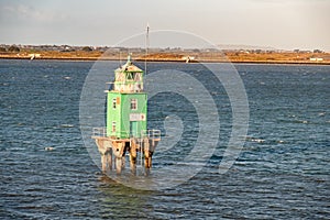 Green buoy tower lighthouse at Dublin harbour