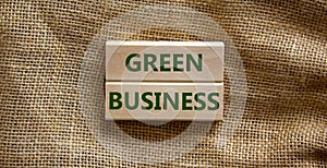 Green business symbol. Wooden blocks form the words `green business` on beautiful canvas background. Business, ecological and