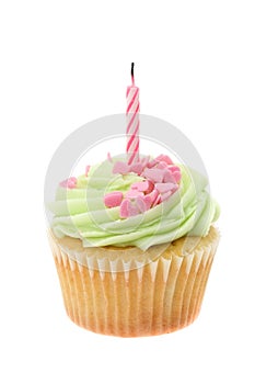 Green buttercream iced cupcake with a single birthday candle