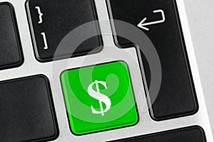 Green button with business cash dollar symbol on the laptop keyboard. E-business concept.
