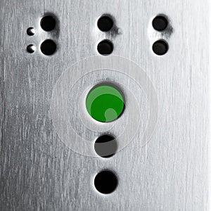 Green Button on Industrial Metal Control Panel
