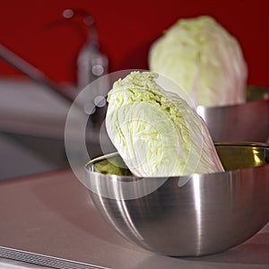 Green cabbage in steel bowl
