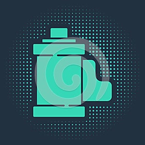 Green Camera vintage film roll cartridge icon isolated on blue background. 35mm film canister. Filmstrip photographer