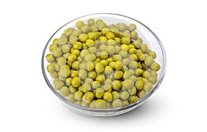 Green canned peas in a glass bowl isolated on a white background