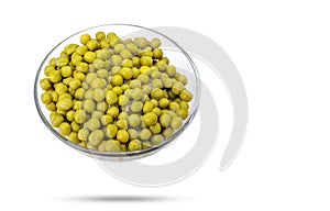 green canned peas in a glass bowl isolated on a white background.