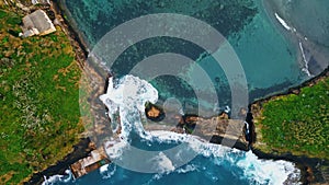 Green cape blue lagoon coastline drone view. Aerial water washing rocky cliff