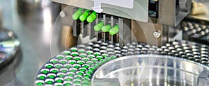 Green capsule medicine pill production line, Industrial pharmaceutical concept photo