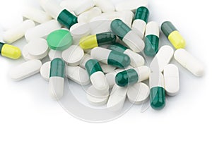 Green capsules and white antibiotic pills.