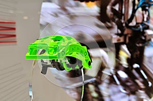 Green car disc brake caliper presented on acrylic glass