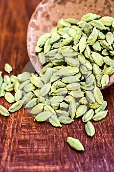 Green cardamom or elachi in a clay bowl.