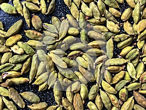 Green cardamon seeds background. Top view