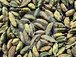 Green cardamon seeds background. Top view