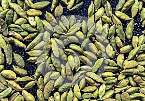 Green cardamon seeds background. top view