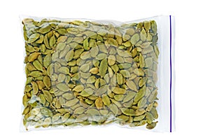 Green cardamon seeds in plastic packet isolated on the white