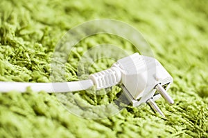 Green carpet on Power Plug Saving energy