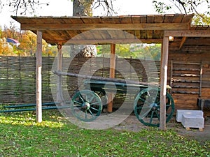 The green cart under wooden canopy