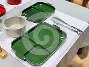 Green ceramic plates on a table in a restaurant. Selective focus.