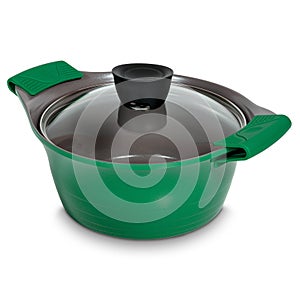 Green ceramic saucepan with transparent glass lid and rubber gloves on white