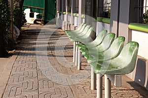 Green chair for waiting buses at bus stop station