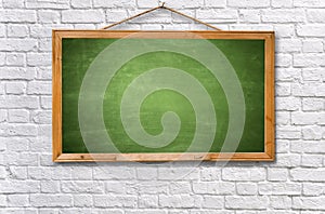 green chalk board on white brick wall