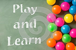 Green chalkboard and colorful balls. Play and learn