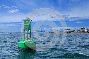 Green channel marker and cruise ship