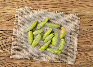 Green cheiro peppers on a rustic fabric over wooden table. Typical brazilian ingredient photo