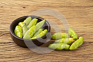 Green cheiro scent/smell pepper on a bowl over wooden table photo