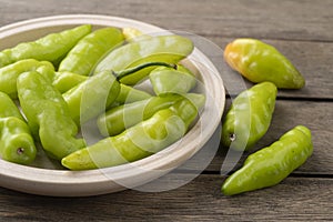 Green cheiro scent/smell pepper on a plate over wooden table photo