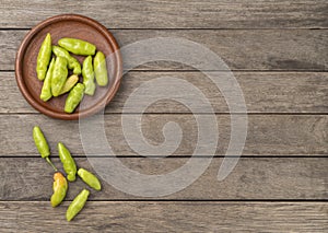 Green cheiro smell,scent peppers on a plate over wooden table with copy space photo