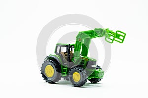 Green children's toy tractor on a white background