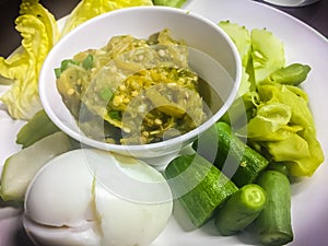 Green chili dip or Nam Prik Num in Thai is green chili paste that eat with boiled egg and boiled vegetables. photo
