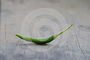 Green chili pepper on wood table