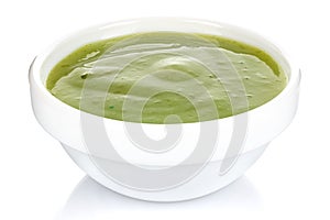 Green chili sauce with lime in a small white ceramic round bowl isolated on white background