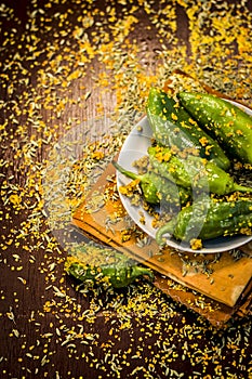 Green chilli pickle marinated in mustard seeds and mustard oil. Dark gothic style still life concept photo