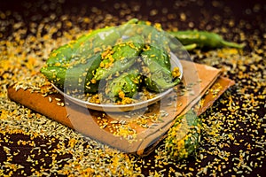 Green chilli pickle marinated in mustard seeds and mustard oil. Dark gothic style still life concept photo