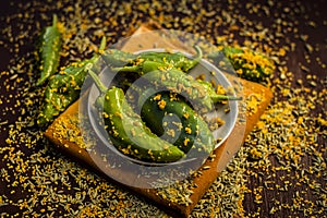 Green chilli pickle marinated in mustard seeds and mustard oil. Dark gothic style still life concept photo